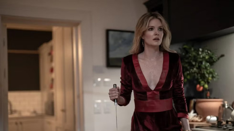 Violet scared and holding a knife in Drop