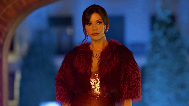 Jackie in a red fur coat looking suspicious in Kill Jackie
