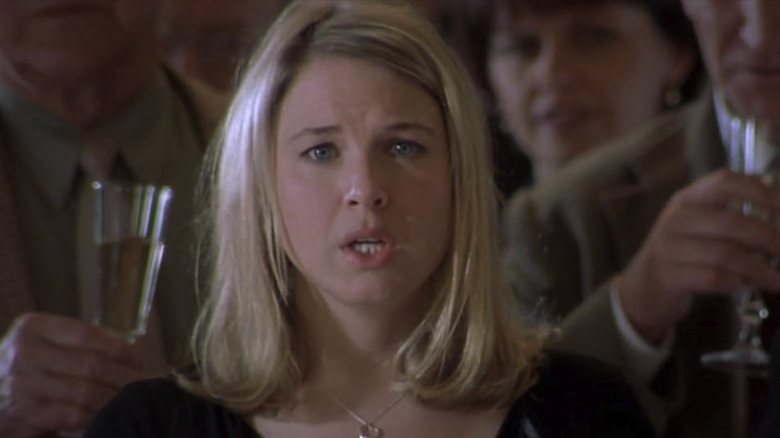 Bridget standing in a crowd with a horrified look on her face in Bridget Jones's Diary