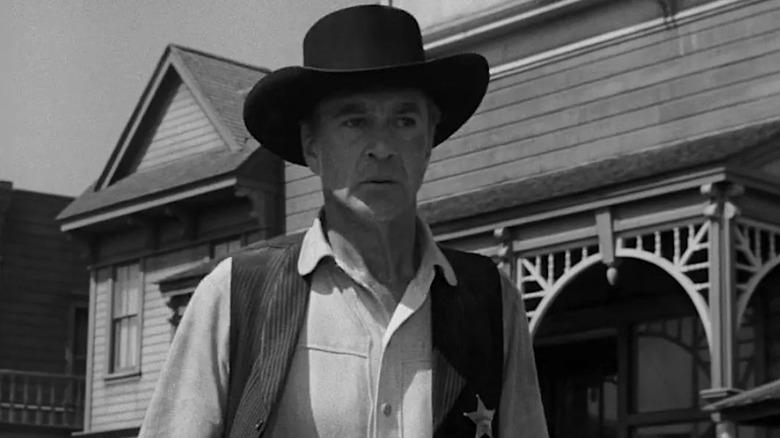 Marshal Will Kane (Gary Cooper) looking alarmed while wearing a black hat in High Noon