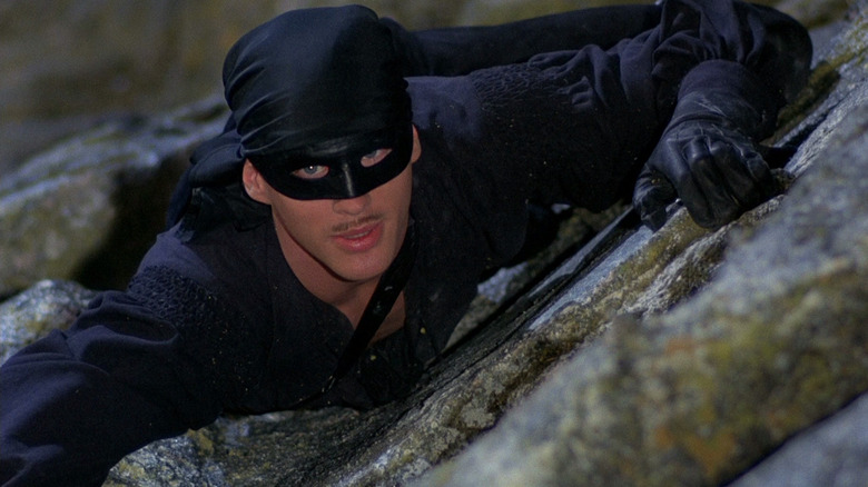 Westley clinging to the side of a cliff in The Princess Bride