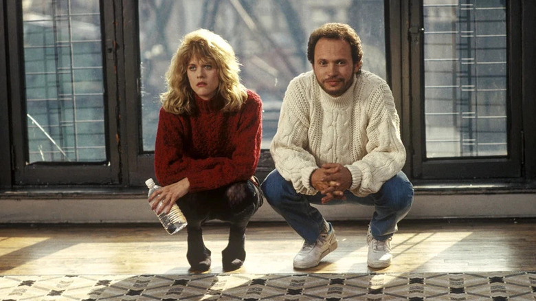 Sally and Harry squatting on a living room floor in When Harry Met Sally