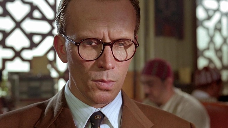 Peter Weller as William Lee wearing glasses in a restaurant in Naked Lunch