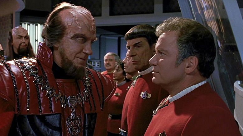 David Warner as Gorkon standing next to William Shatner as James Kirk while Leonard Nimoy as Spock looks on in Star Trek VI: The Undiscovered Country