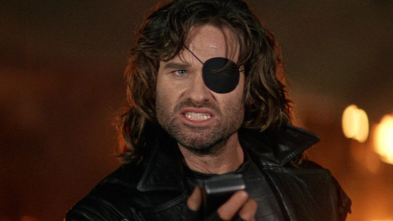 Snake Plissken holding a walkie talkie in Escape from L.A.