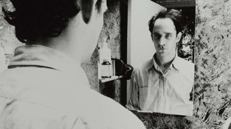 Max Cohen looks at himself in the mirror in Pi