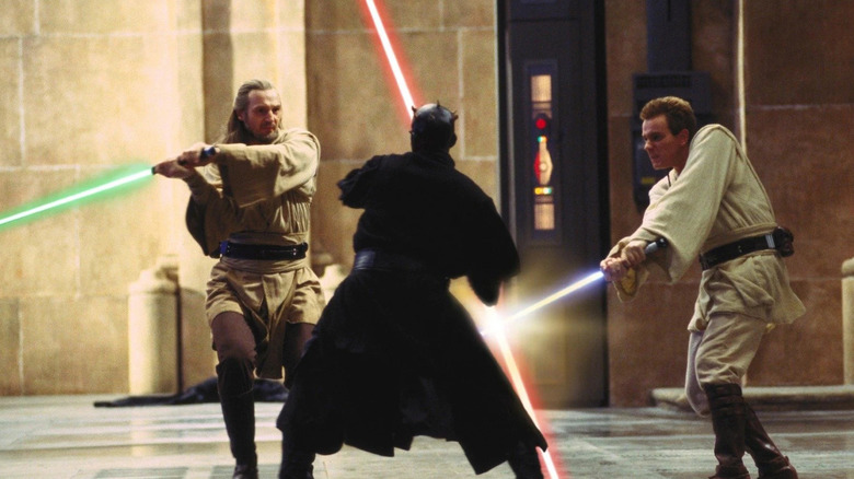 Qui-Gon Jinn and Obi-Wan Kenobi fighting Darth Maul with their lightsabers in Star Wars: The Phantom Menace