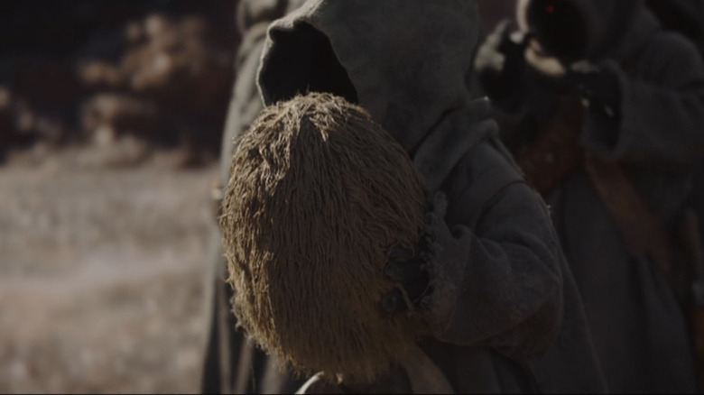 An off-world Jawa with a mudhorn egg in The Mandalorian