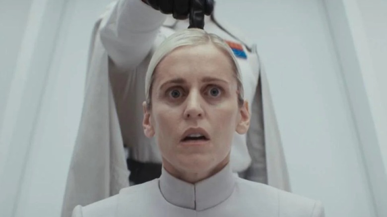 Krennic with his finger placed on Dedra's head in Andor