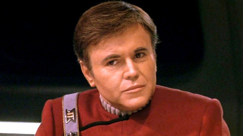 Commander Chekov sitting at a dinner table in Star Tre VI: The Undiscovered Country