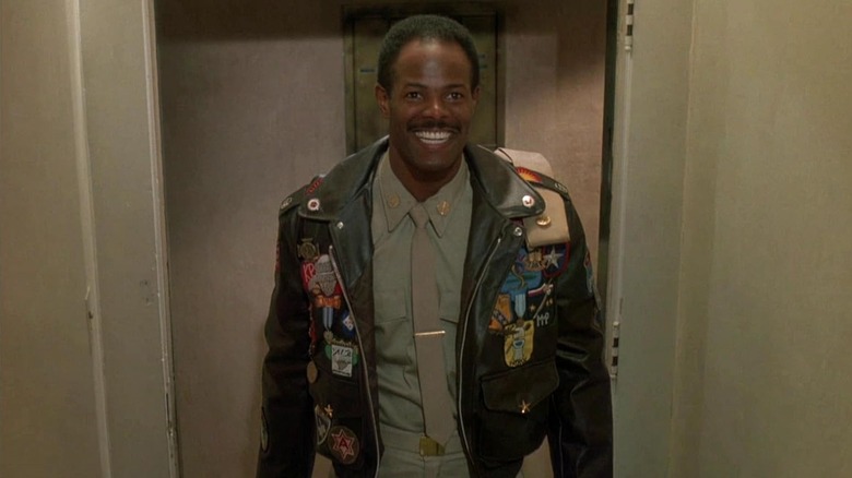 Keenen Ivory Wayans as Jack Spade smiles while wearing a military jacket in I'm Gonna Git You Sucka