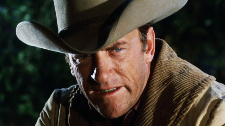 James Arness' Matt Dillon is seen in closeup as he looks out from under his hat in Gunsmoke