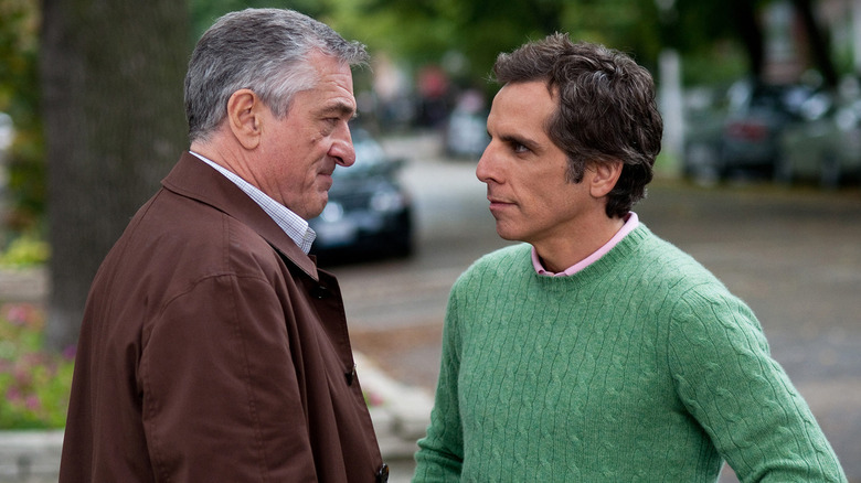 Robert De Niro as Jack Byrnes and Ben Stiller as Greg Focker standing face-to-face in Little Fockers