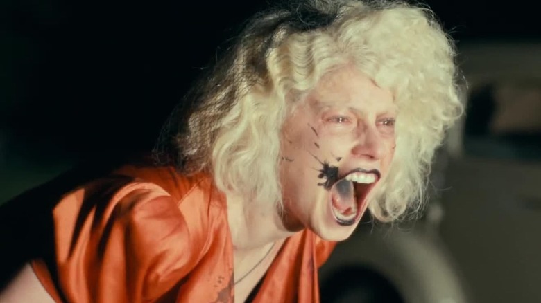 Jessie Buckley as the Bride yelling in the street at night in The Bride!