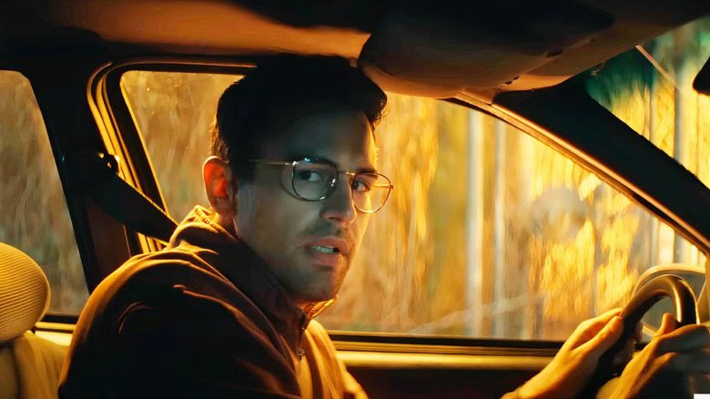 Hal in the front seat of a car in The Monkey