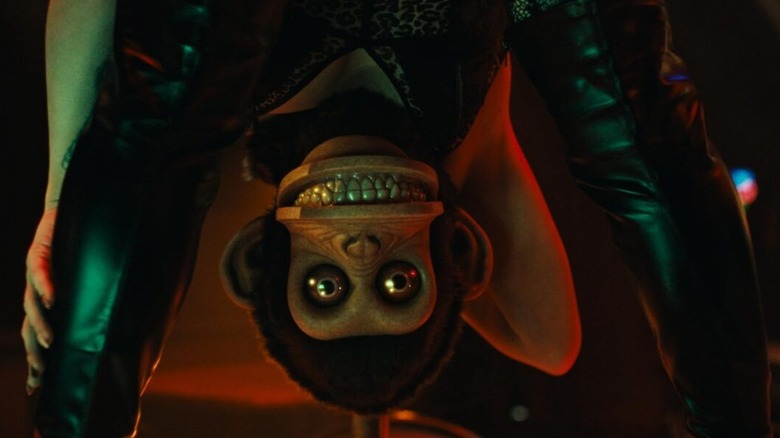 A stripper with a monkey for a head bending over in The Monkey