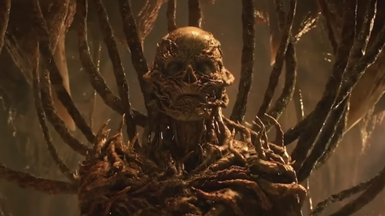 Jamie Campbell Bower's Vecna is seen with his eyes shut inside the MInd Flayer in Stranger Things