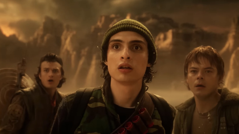 Joe Keery's Steve Harrington, Finn Wolfhard's Mike Wheeler, and Charlie Heaton's Jonathan Byers stand side by side in the Abyss in Stranger Things