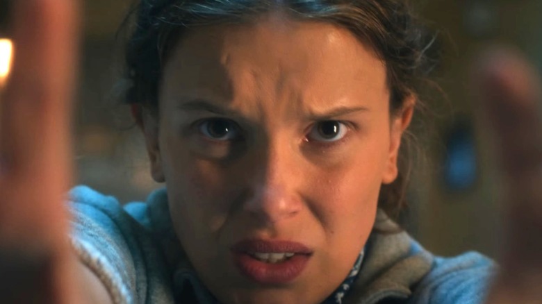 Eleven (Millie Bobby Brown) holding her hands up in the Stranger Things season 5 trailer