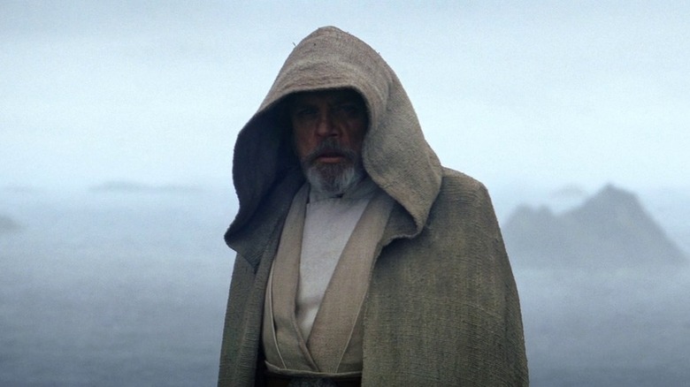 Mark Hamill as Luke Skywalker standing on the cliff at the end of Star Wars: The Force Awakens