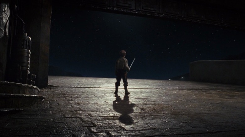 The broom boy looking up at the stars at the end of Star Wars: The Last Jedi