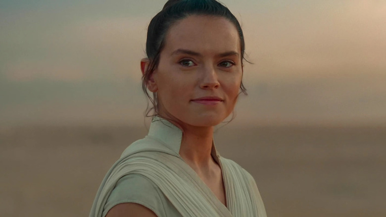 Daisy Ridley as Rey smiling on Tatooine at the end of Star Wars: The Rise of Skywalker