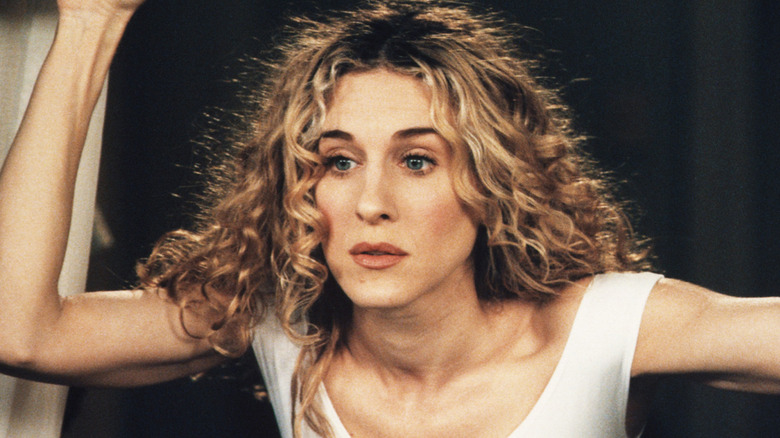 Carrie leaning outside her window on Sex and the City