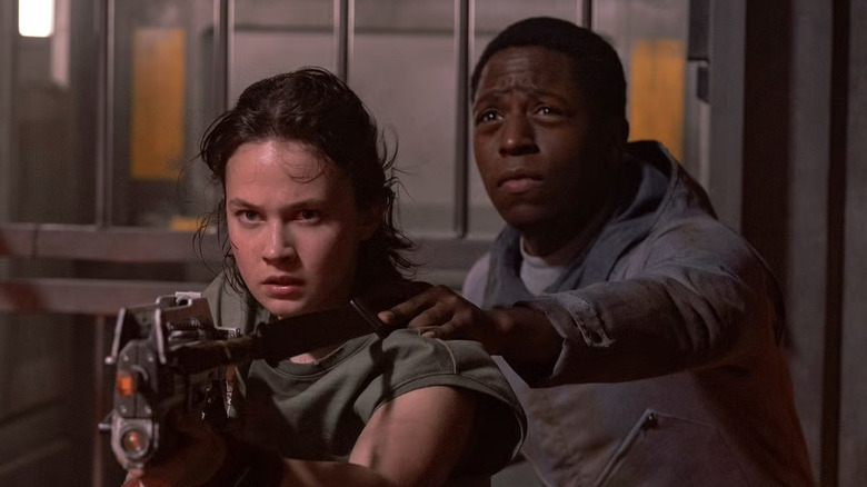 Rain with Andy behind her looking at something in Alien: Romulus