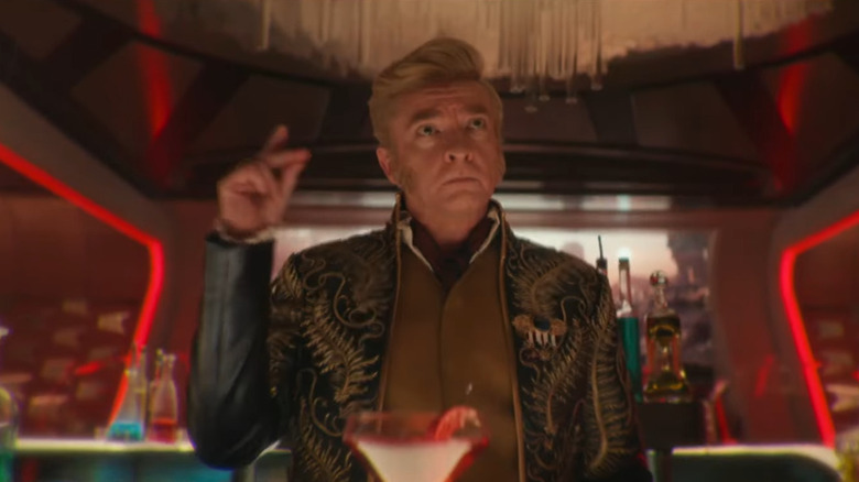 A character played by Rhys Darby, about to snap his fingers behind a bar in Star Trek: Strange New Worlds