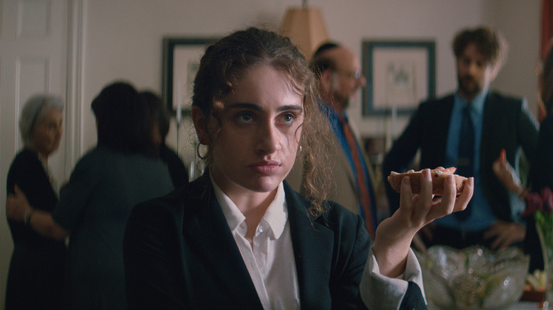 Danielle holding a bagel in Shiva Baby