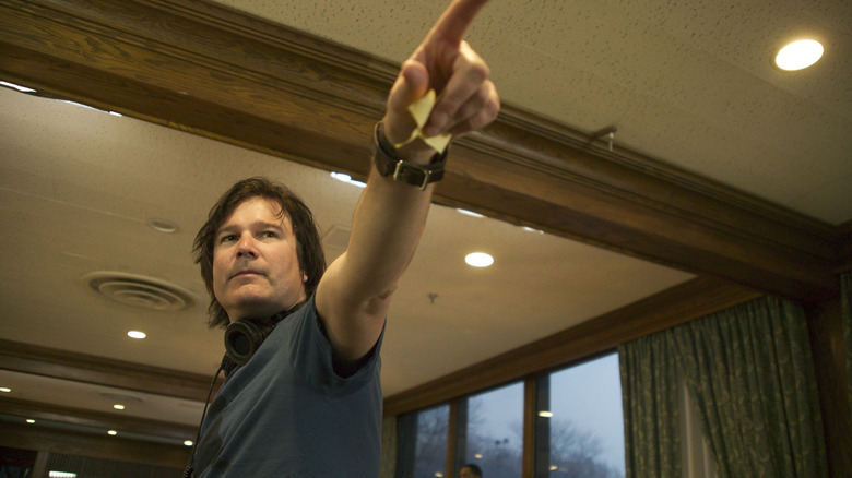 Director Gore Verbinski pointing at something off-screen in a behind-the-scenes still from the set of The Weather Man