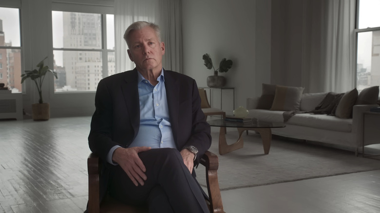 Chris Hansen sits in a chair being interviewed in Predators