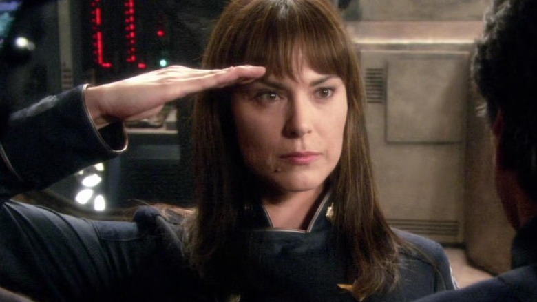 Battlestar Galactica - Admiral Cain (Michelle Forbes) doing a salute in front of Commander Adama and marine