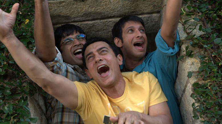 Rancho and his two buddies singing out a window in the film 3 Idiots