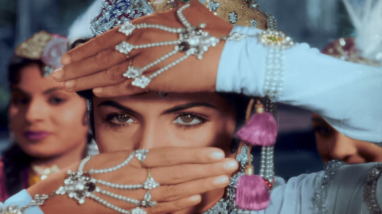 Anarkali looking through her hands in Mughal-e-Azam