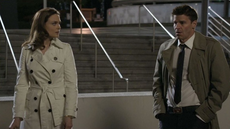 Emily Deschanel as Temperance Brennan and David Boreanaz as Seeley Booth standing side by side on Bones
