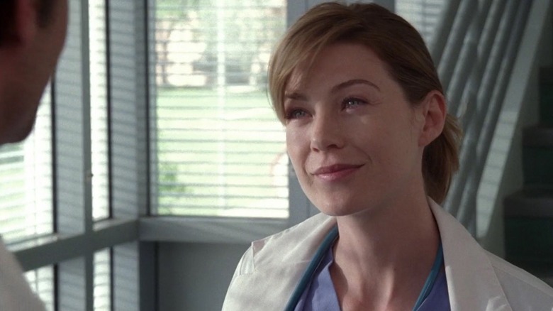 Meredith smiling at Derek in the stairwell on Grey's Anatomy