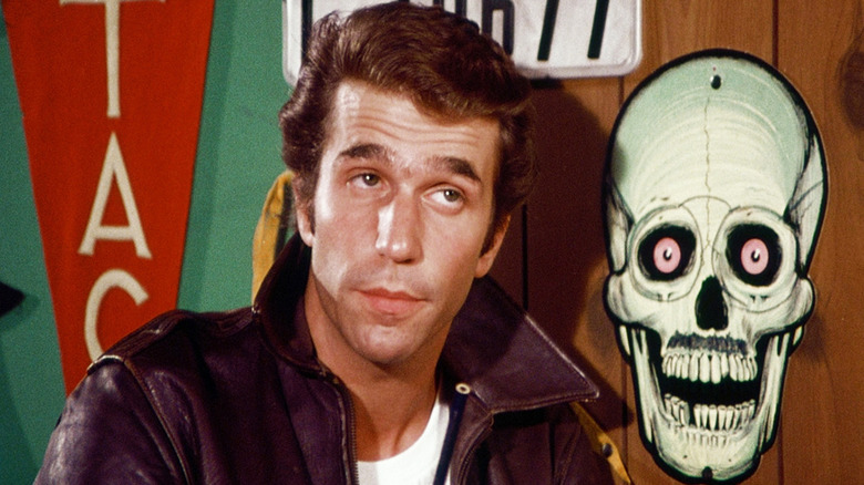 Henry Winkler's Fonzie next to a skull painting on Happy Days