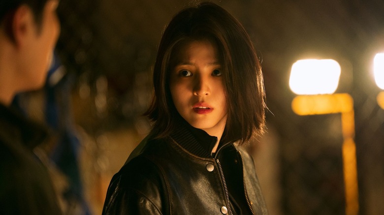 Joon Ji-woo (Han So-hee) stares at a man in a darkened room in My Name