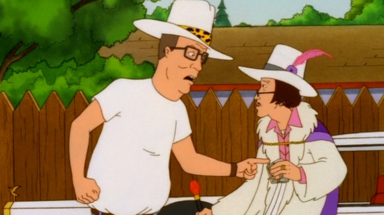 Hank Hill wearing a flamboyant hat and threatening Alabaster Jones on King of the Hill