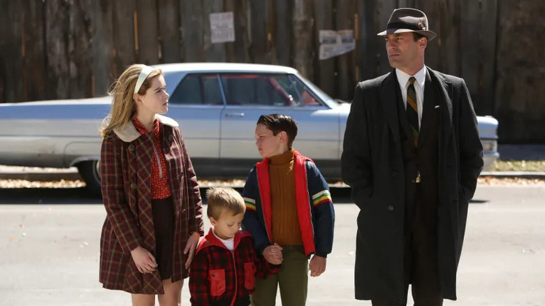 Sally Gene Bobby and Don standing on the street in front of a car on Mad Men