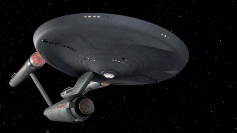 The Enterprise flying away from Deep Space K-4 on Star Trek
