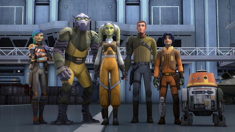 Sabine (Tiya Sircar), Zeb (Steve Blum), Hera (Vanessa Marshall), Kanan (Freddie Prinze Jr.), Ezra (Taylor Gray), and Chopper (Dave Filoni) standing together in Star Wars Rebels