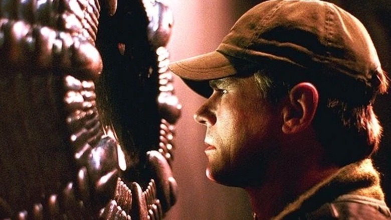 Richard Dean Anderson's O'Neill looking at a strange machine on Stargate SG-1