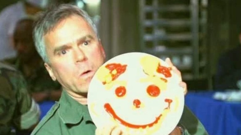 Richard Dean Anderson's O'Neill with a smiley face painting on Stargate SG-1