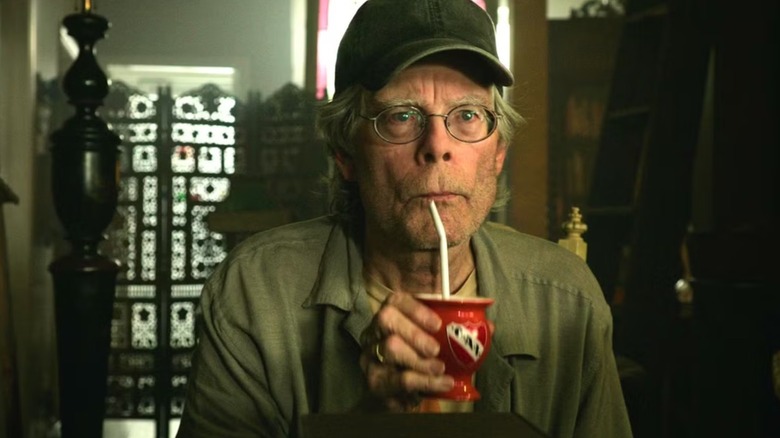 Stephen King drinking from a straw