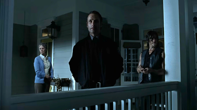 The Walking Dead, Rick on a porch at night, with Carol on his left and Daryl on his right