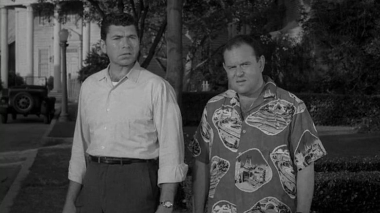 Two Maple Street neighbors looking worried in The Twilight Zone