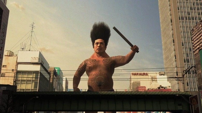 Masaru as a giant man with a baton in Big Man Japan