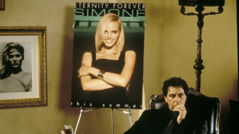 Viktor Taransky in front of a poster of Simone in Simone